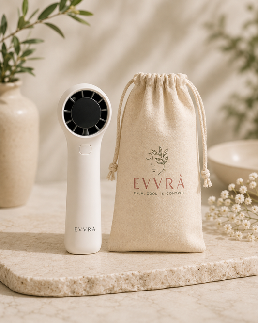 White EVVRA handheld personal fan with black center and matching drawstring bag on a neutral background